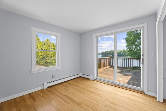 538 Quaddick Rd, Thompson, CT 06277 - spare room with a baseboard heating unit, light wood-style floors, and a water view