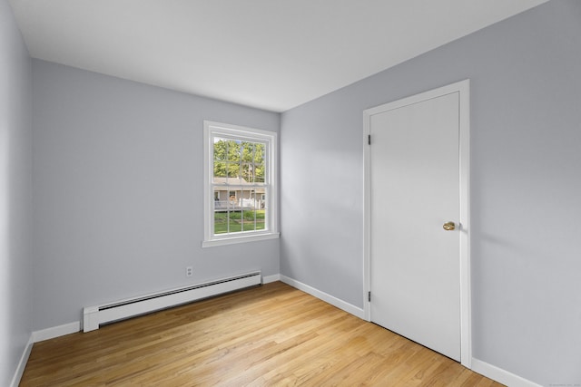 538 Quaddick Rd, Thompson, CT 06277 - empty room featuring a baseboard heating unit and wood finished floors