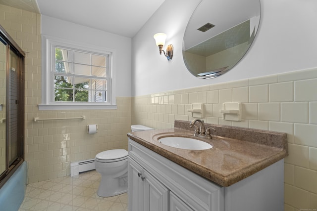 538 Quaddick Rd, Thompson, CT 06277 - bathroom featuring tile walls, baseboard heating, vanity, a wainscoted wall, and bath / shower combo with glass door