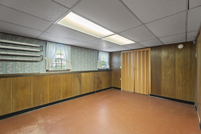 538 Quaddick Rd, Thompson, CT 06277 - basement featuring a drop ceiling, wooden walls, and wallpapered walls