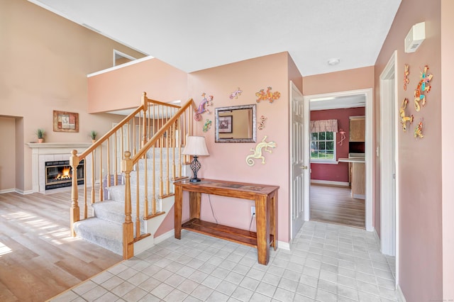 56 Stagecoach Cir, Milford, CT 06460 - stairs with a fireplace and tile patterned flooring