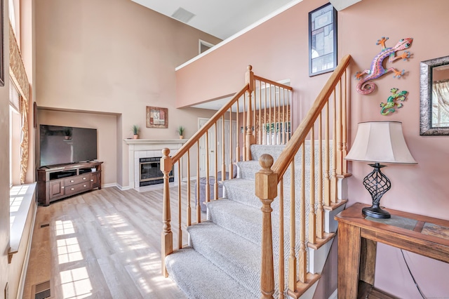 56 Stagecoach Cir, Milford, CT 06460 - stairs featuring a fireplace and a towering ceiling