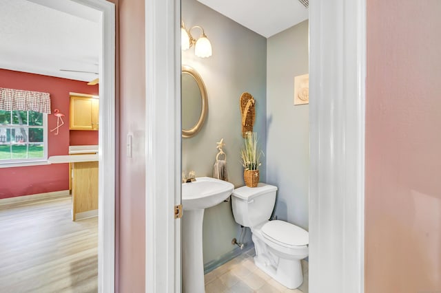 56 Stagecoach Cir, Milford, CT 06460 - bathroom featuring toilet and baseboards