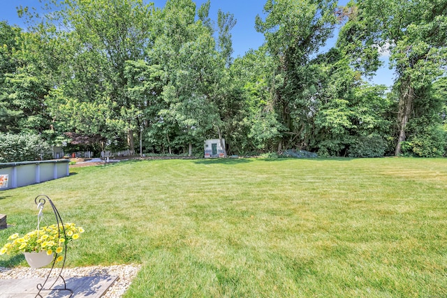 56 Stagecoach Cir, Milford, CT 06460 - view of grassy yard featuring a covered pool