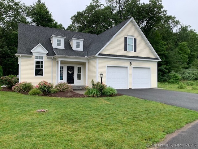 98 Cambridge Ct Unit 98, Simsbury, CT 06070 - view of front of house featuring a garage, asphalt driveway, and a front lawn
