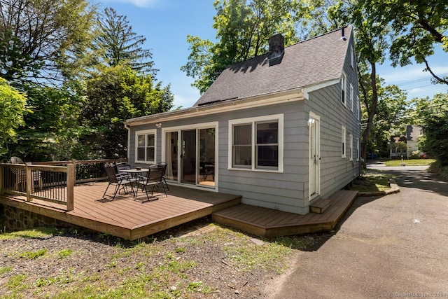 141 Cannon St, Hamden, CT 06518 - rear view of house with outdoor dining area, a shingled roof, a chimney, and a wooden deck