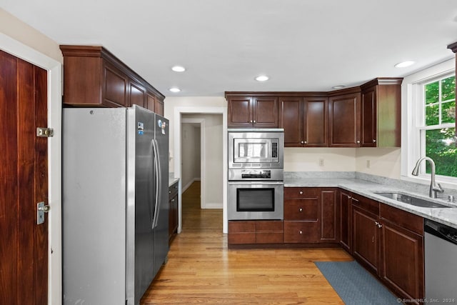 141 Cannon St, Hamden, CT 06518 - kitchen with appliances with stainless steel finishes, light wood-type flooring, light stone counters, recessed lighting, and dark brown cabinets