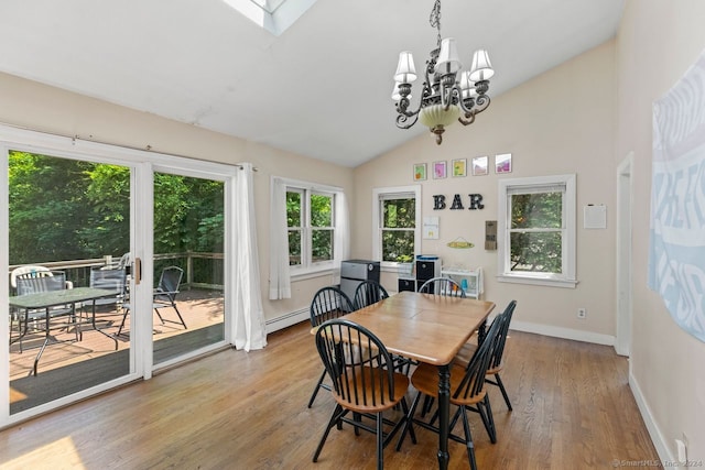 141 Cannon St, Hamden, CT 06518 - dining room with wood finished floors, a chandelier, baseboard heating, lofted ceiling, and a skylight