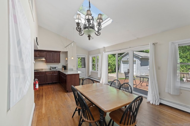 141 Cannon St, Hamden, CT 06518 - dining room with a baseboard radiator, light wood-style floors, a chandelier, and lofted ceiling