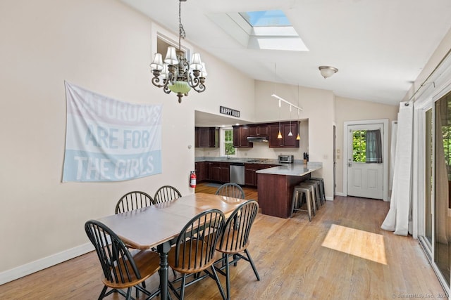 141 Cannon St, Hamden, CT 06518 - dining area with vaulted ceiling, a skylight, light wood finished floors, and a chandelier