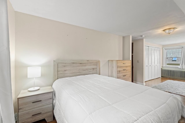141 Cannon St, Hamden, CT 06518 - bedroom with radiator, a closet, and wood finished floors