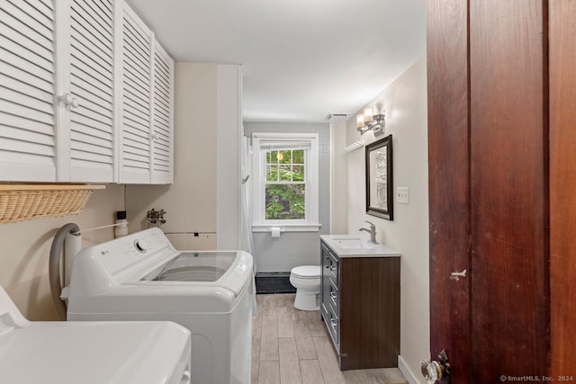 141 Cannon St, Hamden, CT 06518 - laundry room with light wood-type flooring and washing machine and dryer