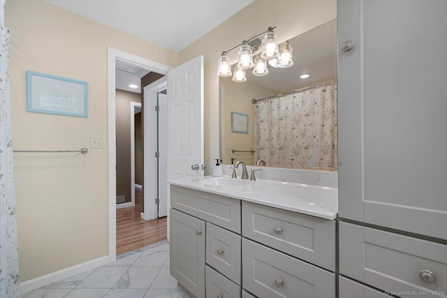 2 Sunwoods Cir, Hamden, CT 06518 - bathroom featuring marble look tiles, vanity, a chandelier, and recessed lighting