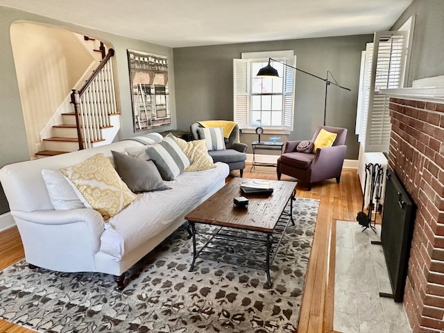 111 Spring Garden St, Hamden, CT 06517 - living area featuring a fireplace, wood finished floors, and stairs