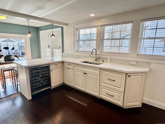 111 Spring Garden St, Hamden, CT 06517 - kitchen featuring beverage cooler, dark wood-style floors, a peninsula, light countertops, and recessed lighting