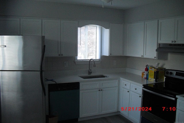 1549 E Main St Unit 30, Meriden, CT 06450 - kitchen with appliances with stainless steel finishes, under cabinet range hood, white cabinetry, and light countertops