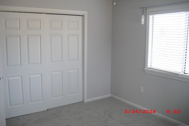 1549 E Main St Unit 30, Meriden, CT 06450 - unfurnished bedroom featuring carpet floors, multiple windows, and a closet
