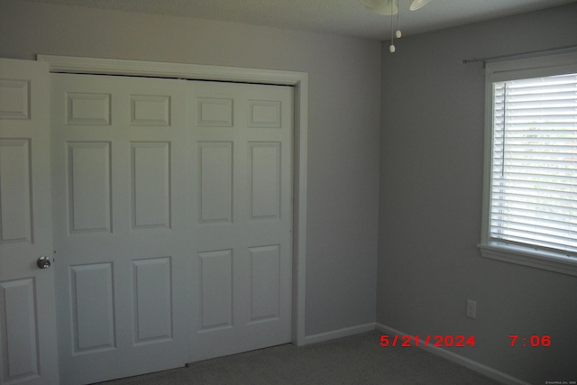 1549 E Main St Unit 30, Meriden, CT 06450 - unfurnished bedroom with carpet, multiple windows, and a closet