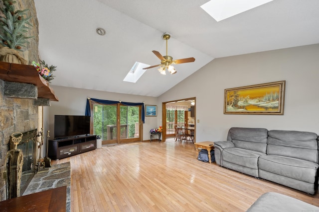 291 Guinevere Rdg, Cheshire, CT 06410 - living room featuring a skylight, wood-type flooring, a stone fireplace, a ceiling fan, and high vaulted ceiling