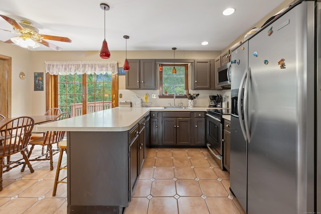 291 Guinevere Rdg, Cheshire, CT 06410 - kitchen featuring stainless steel appliances, a peninsula, light countertops, recessed lighting, and a breakfast bar