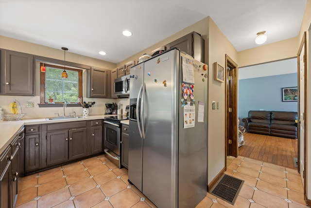 291 Guinevere Rdg, Cheshire, CT 06410 - kitchen with stainless steel appliances, light tile patterned floors, light countertops, hanging light fixtures, and recessed lighting