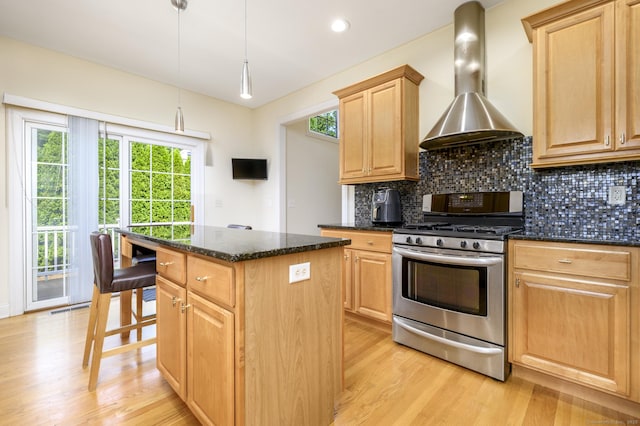 7 Castlewood Dr Unit 7, Monroe, CT 06468 - kitchen with gas range, wall chimney exhaust hood, a center island, light wood-style flooring, and light brown cabinets