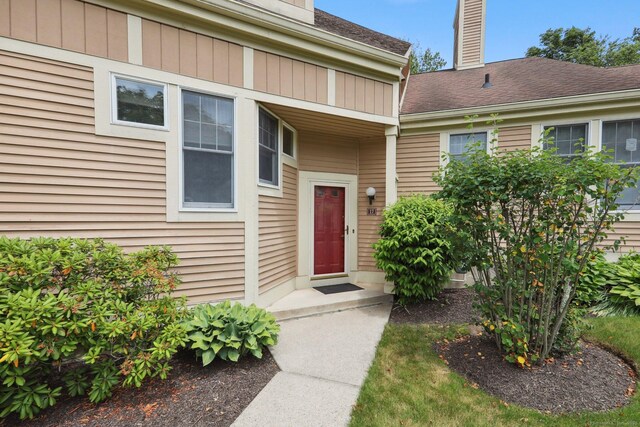 17 Brittania Dr Unit 17, Danbury, CT 06811 - view of exterior entry featuring a chimney and a shingled roof