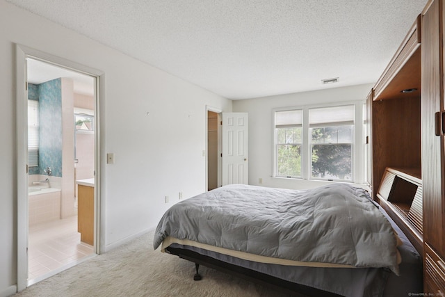 17 Brittania Dr Unit 17, Danbury, CT 06811 - bedroom with light carpet, a textured ceiling, and ensuite bathroom