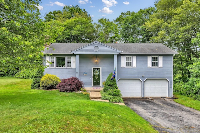 81 Charter Oak Dr, East Lyme, CT 06333 - bi-level home featuring asphalt driveway, an attached garage, a front yard, a shingled roof, and view of scattered trees