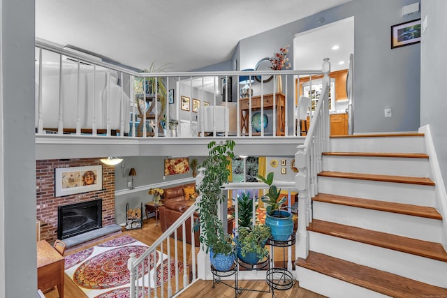 81 Charter Oak Dr, East Lyme, CT 06333 - staircase with wood finished floors and a brick fireplace