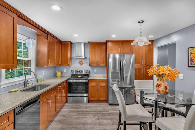 81 Charter Oak Dr, East Lyme, CT 06333 - kitchen with stainless steel appliances, wall chimney range hood, brown cabinets, recessed lighting, and decorative light fixtures