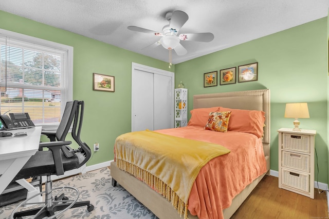 81 Charter Oak Dr, East Lyme, CT 06333 - bedroom featuring an office area, a closet, a ceiling fan, and wood finished floors
