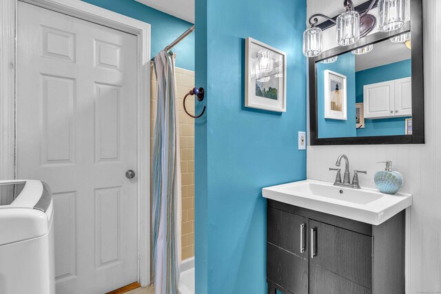 81 Charter Oak Dr, East Lyme, CT 06333 - bathroom featuring washer / clothes dryer, vanity, and shower / bath combo with shower curtain