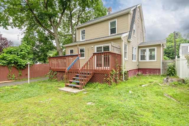49 Olmsted St, East Hartford, CT 06108 - back of property featuring a fenced backyard, a deck, and a chimney