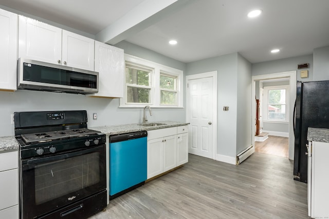 49 Olmsted St, East Hartford, CT 06108 - kitchen with black appliances, light wood-type flooring, white cabinetry, a baseboard radiator, and light stone counters