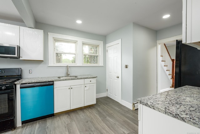 49 Olmsted St, East Hartford, CT 06108 - kitchen with black appliances, light wood finished floors, white cabinets, light stone countertops, and recessed lighting