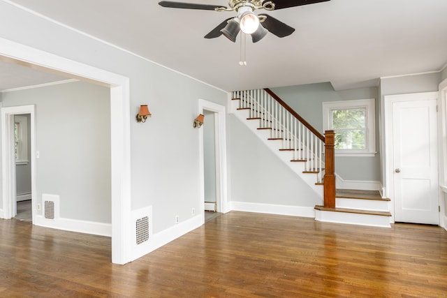 49 Olmsted St, East Hartford, CT 06108 - unfurnished living room featuring a ceiling fan, stairway, wood finished floors, baseboard heating, and crown molding