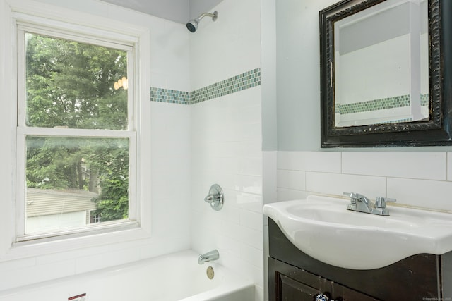 49 Olmsted St, East Hartford, CT 06108 - bathroom with vanity,  shower combination, and tile walls
