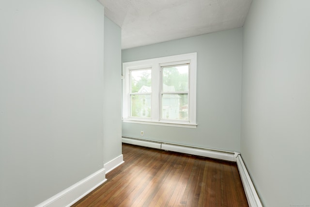49 Olmsted St, East Hartford, CT 06108 - empty room featuring baseboard heating, hardwood / wood-style floors, and a baseboard radiator