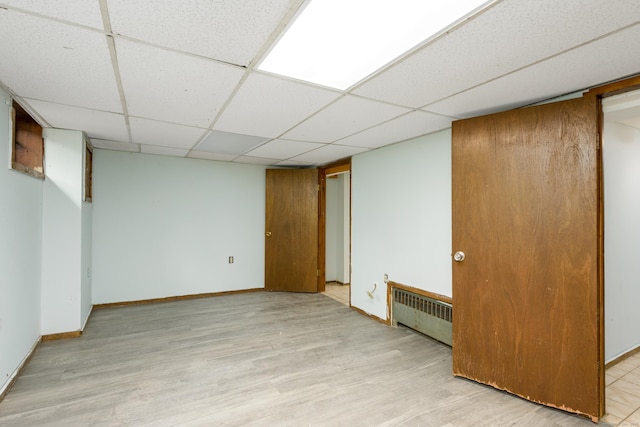 49 Olmsted St, East Hartford, CT 06108 - finished basement featuring radiator heating unit, light wood-style floors, and a paneled ceiling