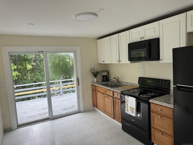 256 Alexander Rd, New Britain, CT 06053 - kitchen featuring black appliances, white cabinets, and brown cabinetry