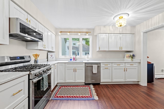 12 Byrne Ct Unit D, Farmington, CT 06032 - kitchen with stainless steel appliances, dark wood finished floors, white cabinetry, and a baseboard heating unit