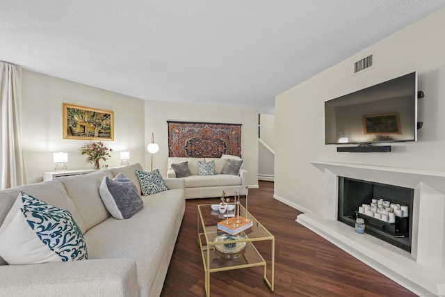 12 Byrne Ct Unit D, Farmington, CT 06032 - living area featuring a baseboard heating unit, wood finished floors, and a fireplace with raised hearth