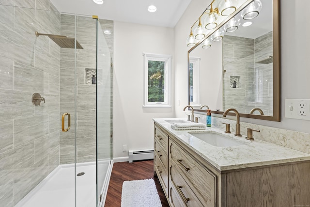12 Byrne Ct Unit D, Farmington, CT 06032 - full bathroom featuring a baseboard heating unit, double vanity, a stall shower, wood finished floors, and recessed lighting