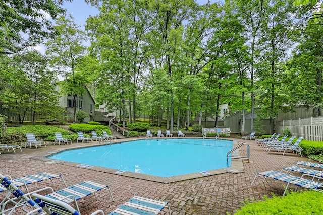 12 Byrne Ct Unit D, Farmington, CT 06032 - community pool with a patio area, stairs, and view of scattered trees