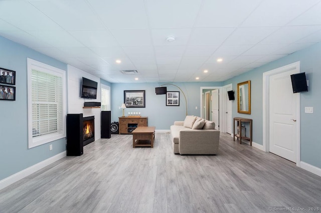 171 Judd Hill Rd, Middlebury, CT 06762 - living room featuring a lit fireplace, wood finished floors, recessed lighting, and a drop ceiling