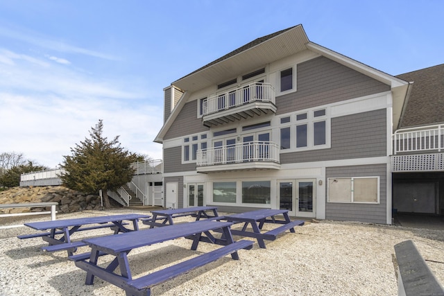 379 Whitfield St, Guilford, CT 06437 - back of property featuring a balcony, french doors, and stairway
