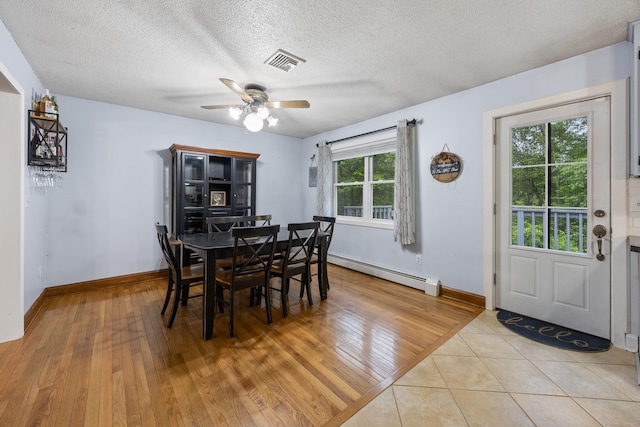 489 Thomaston Rd, Watertown, CT 06795 - dining space with baseboard heating, a ceiling fan, light wood-type flooring, and a textured ceiling
