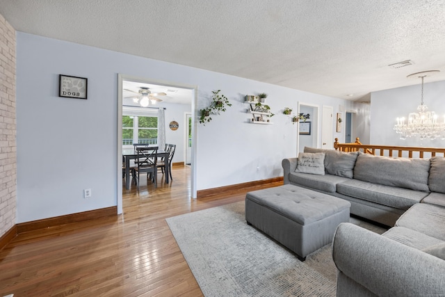 489 Thomaston Rd, Watertown, CT 06795 - living area featuring a chandelier, light wood-style flooring, a textured ceiling, and a ceiling fan