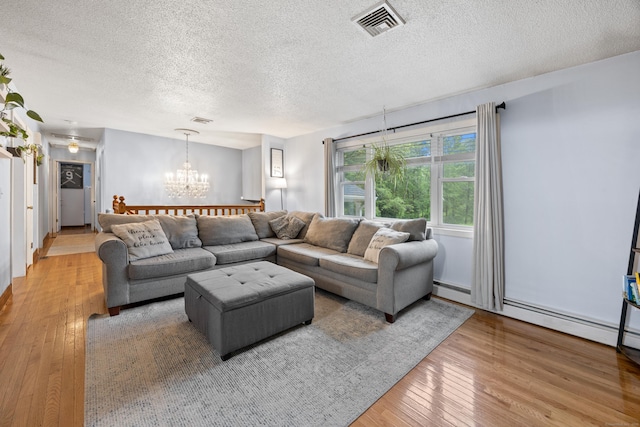 489 Thomaston Rd, Watertown, CT 06795 - living area with a textured ceiling, a chandelier, and wood-type flooring